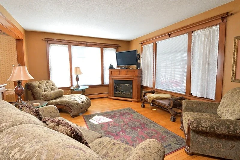 Living room with TV and fireplace in The Cottage home