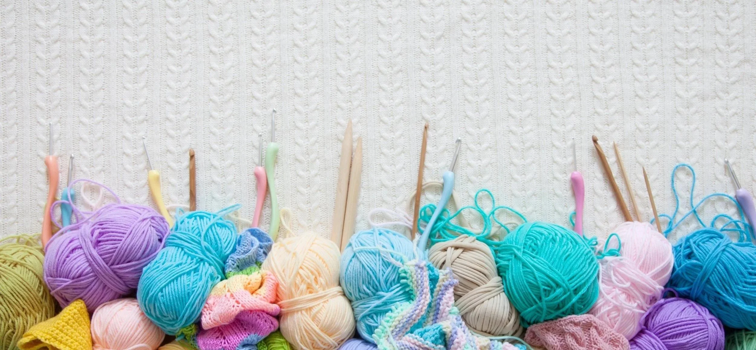 Colorful yarn on sweater background.