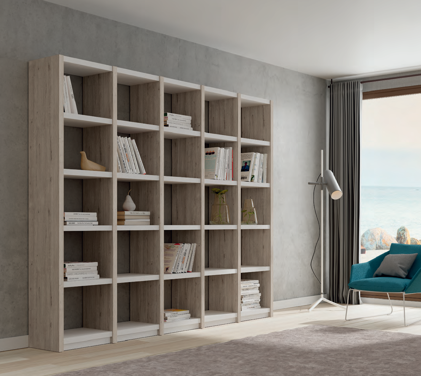 Living room with a large wooden bookshelf, a floor lamp, a teal armchair with a pillow, and a window with curtains revealing an ocean view.