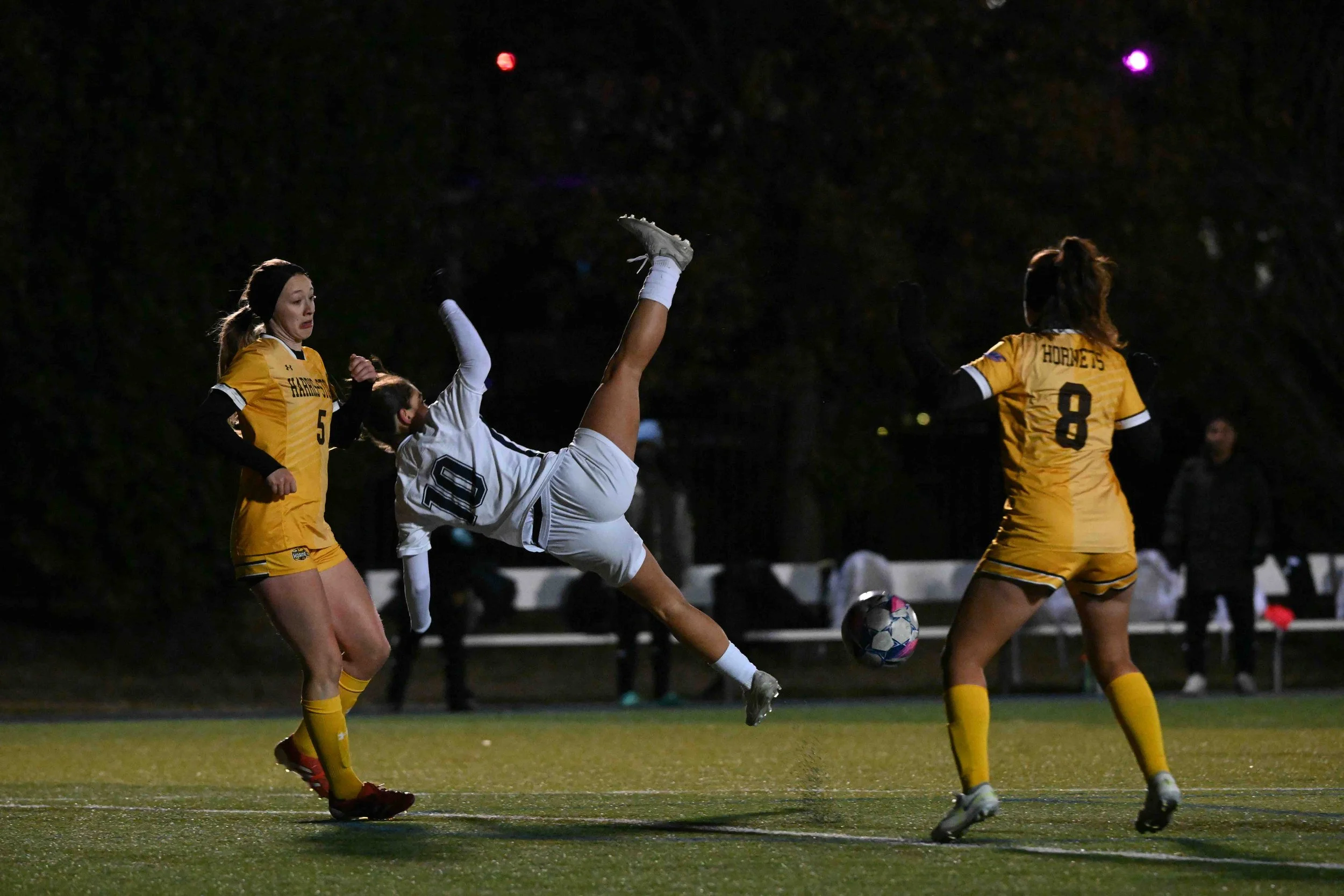 Columbia College midfielder Georgia Pardalos (10) misses a bicycle kick against Harris-Stowe State University defender Luka Gorogranz (5) and midfielder Alexandra Forcelius (8) in the AMC Tournament Championship game on Monday, Nov. 11, 2025, at R. M