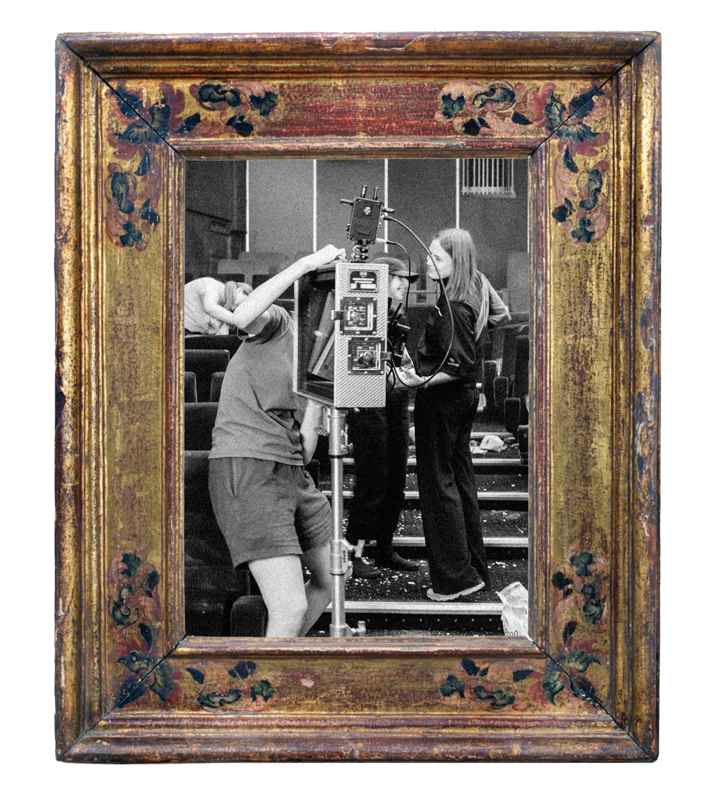 Behind the scenes of a film or TV production, people working on a camera or equipment, framed within an ornate gold and floral picture frame.