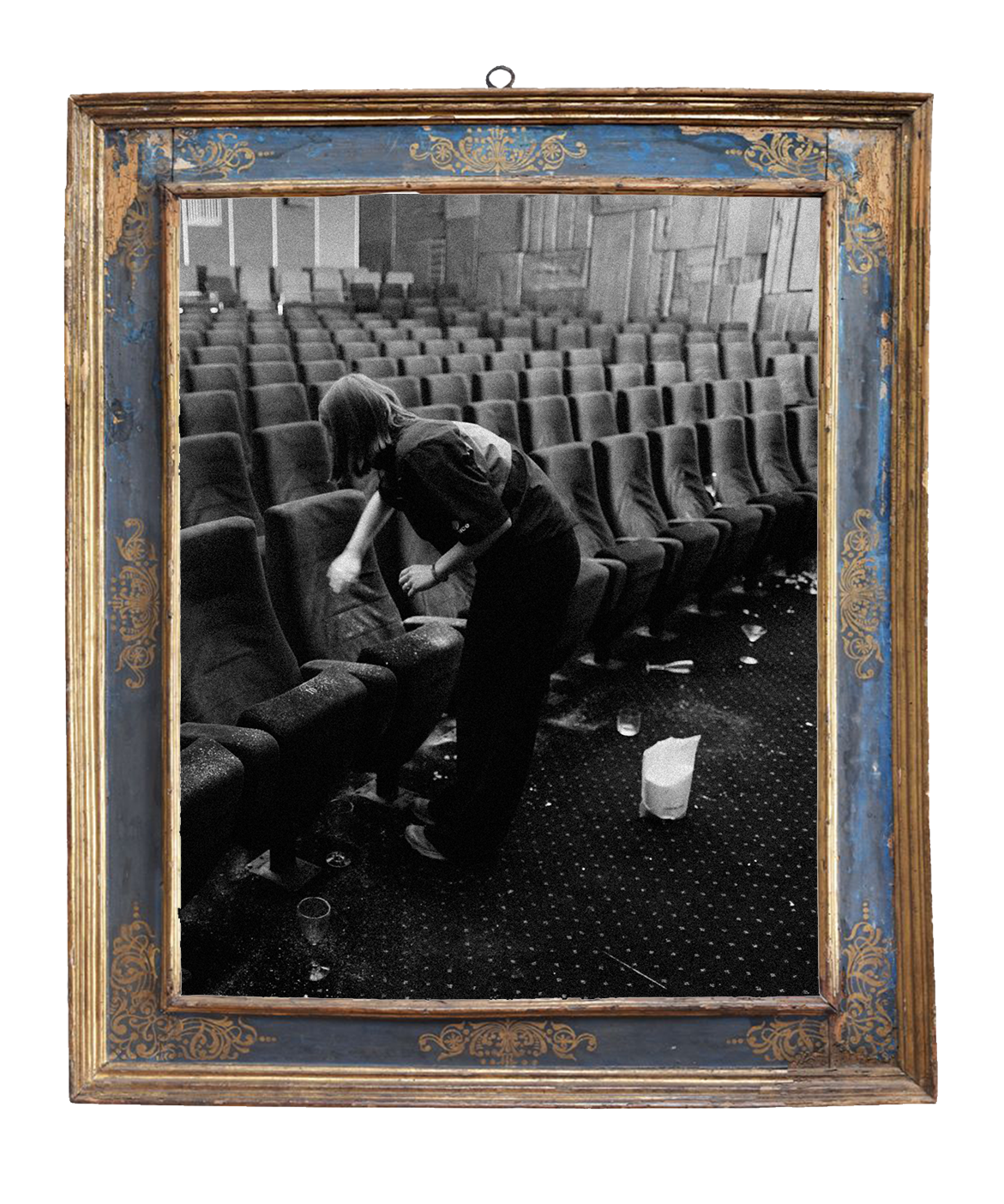 A woman cleaning a theater or auditorium with empty chairs, scattered trash, and a trash can on the floor.