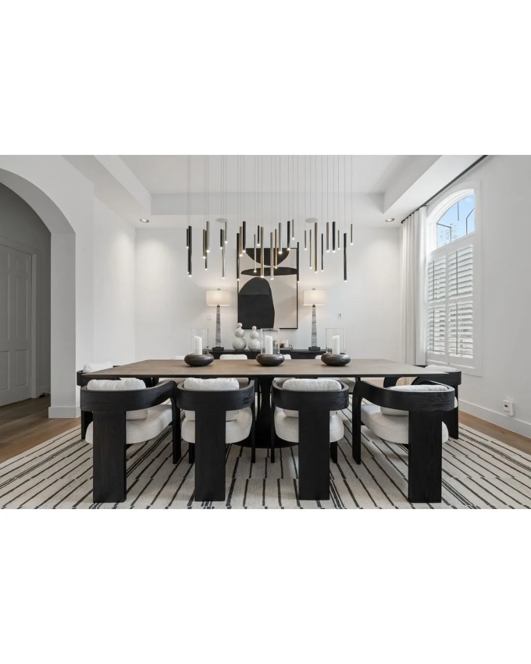 If the crowd grows too large for the kitchen and breakfast area, the dining room easily seats 10 additional guests.

The linear chandelier echoes the pattern in the rug as well as the vertical detailing on the chair backs&mdash;an intentional move, n