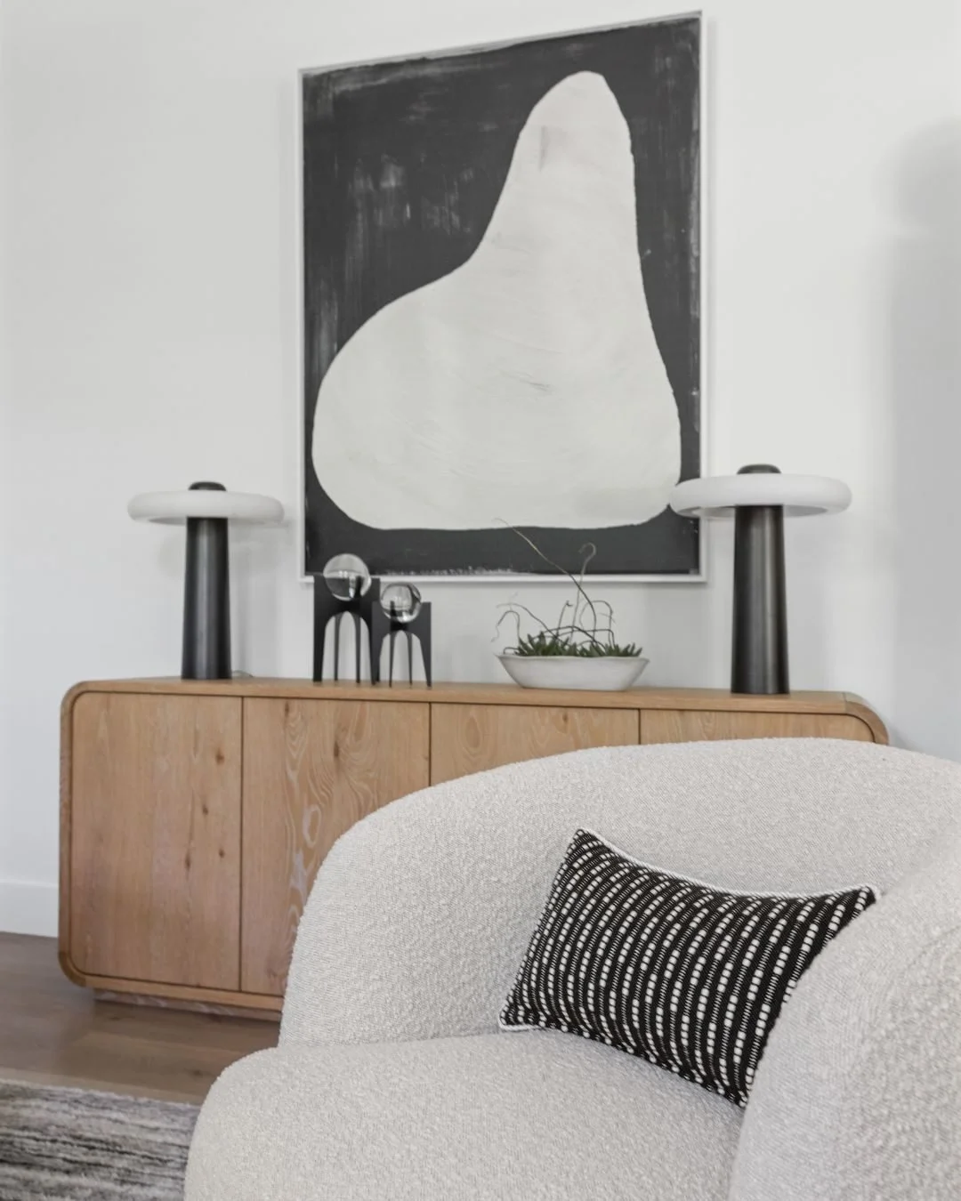 This vignette captures one side of what was once labeled the formal living room, but the family didn&rsquo;t want any space to feel untouchable, so the goal was to make it warm and conversation-friendly. Four chairs arranged in a circle, all facing i