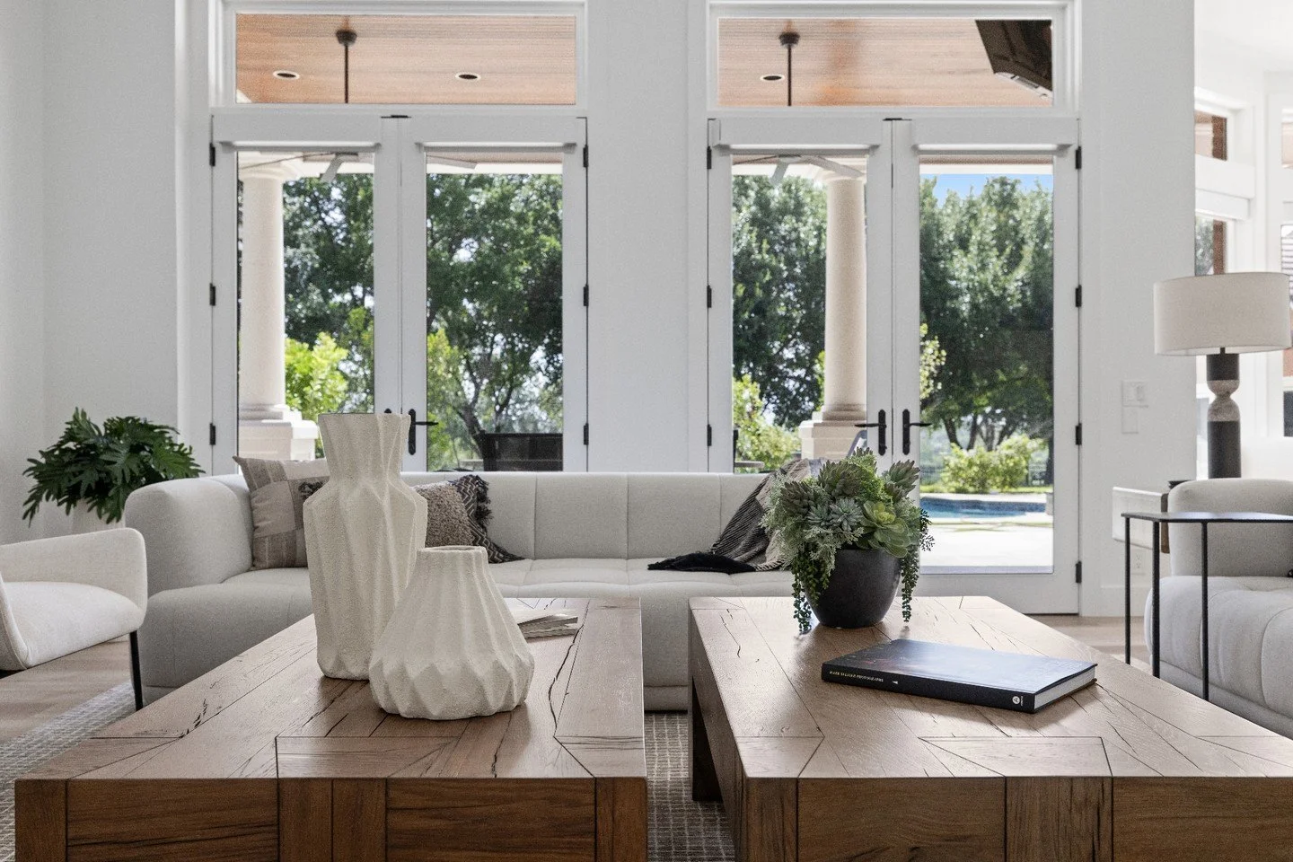 This straight-on view of the family room offers a look past the pool and into the expansive backyard beyond. The pool itself becomes another gathering spot for the family&mdash;a place to spend time together and cool off during those hot Texas summer