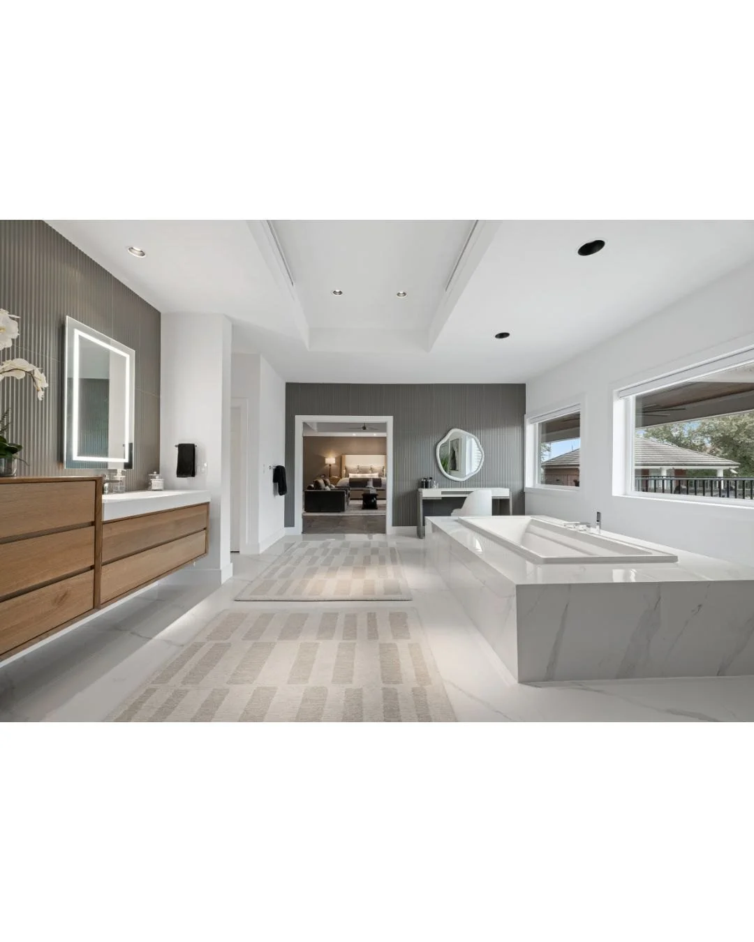The final image I&rsquo;d like to share from this primary suite is this view into the bathroom, offering a closer look at the custom vanity we designed. Custom cabinetry really shines here, since it lets us build storage that fits exactly how our cli