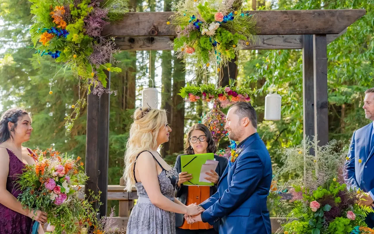 Wedding arch arrangement with flowers and forest background