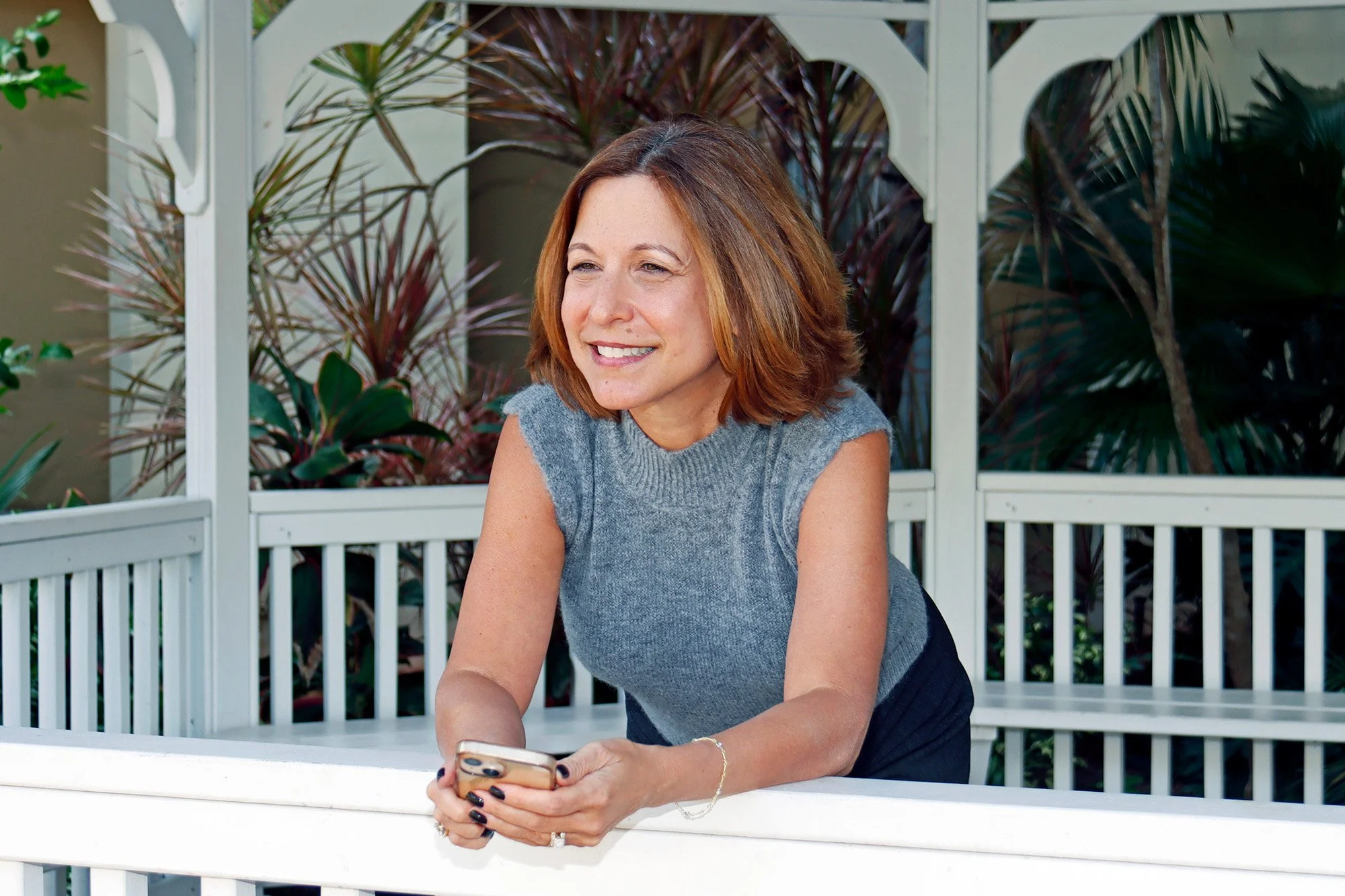 Leadership consultant, Stacy, holding her phone, looking off camera