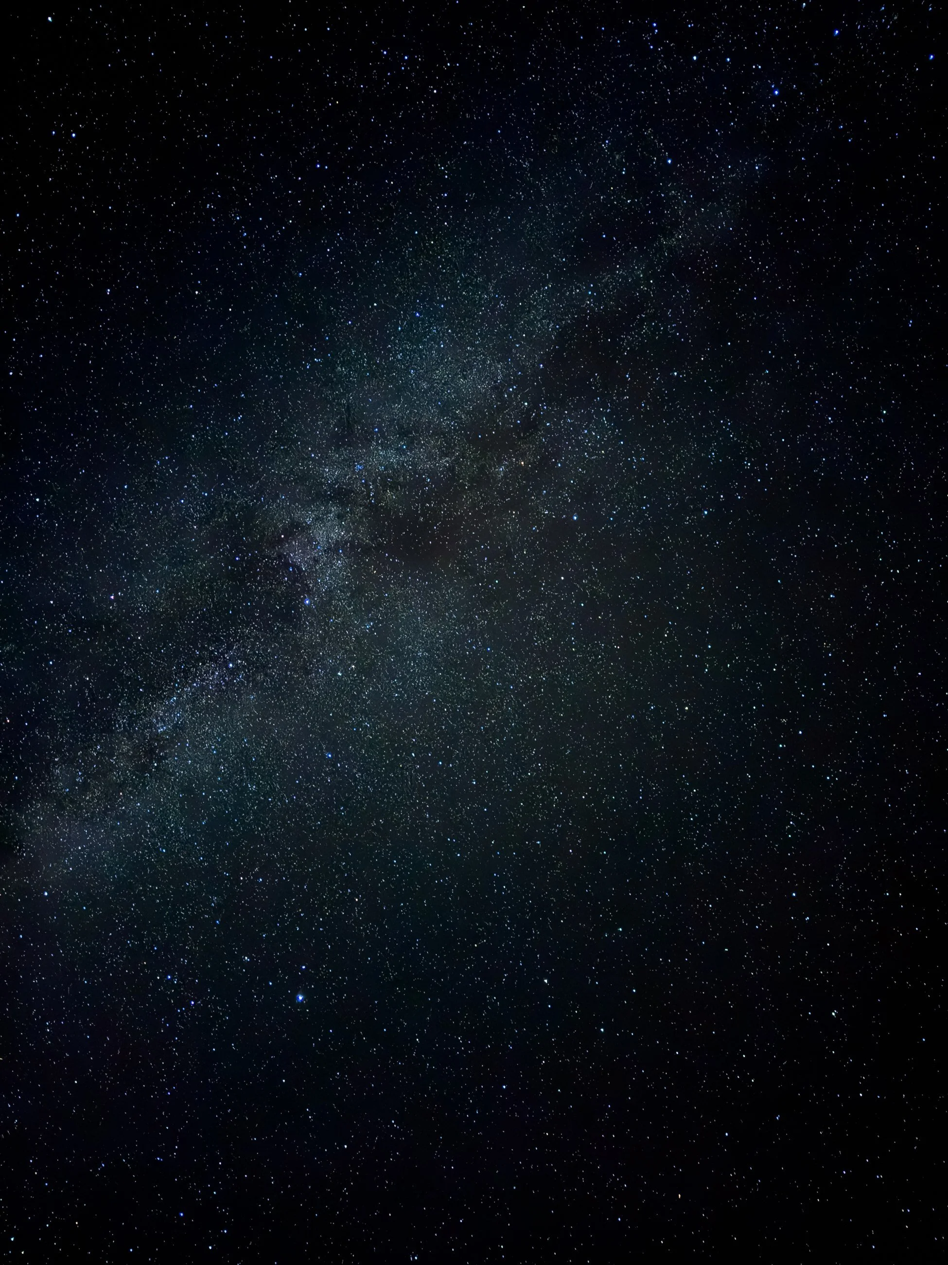 The Milky Way stretches across a star-filled night sky.