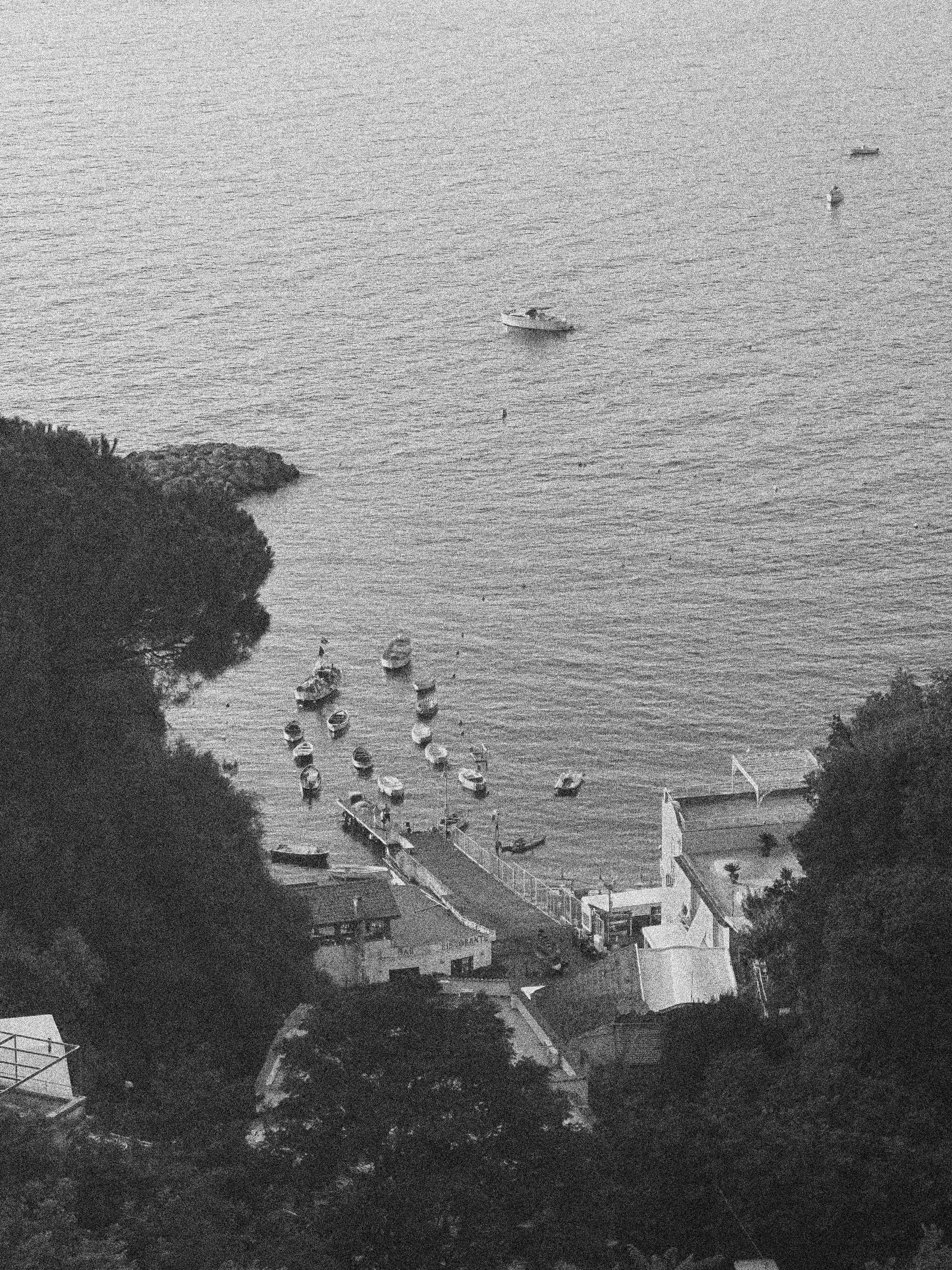 BOATS IN THE WATER AT SUNSET IN VICO EQUENSE , ITALY