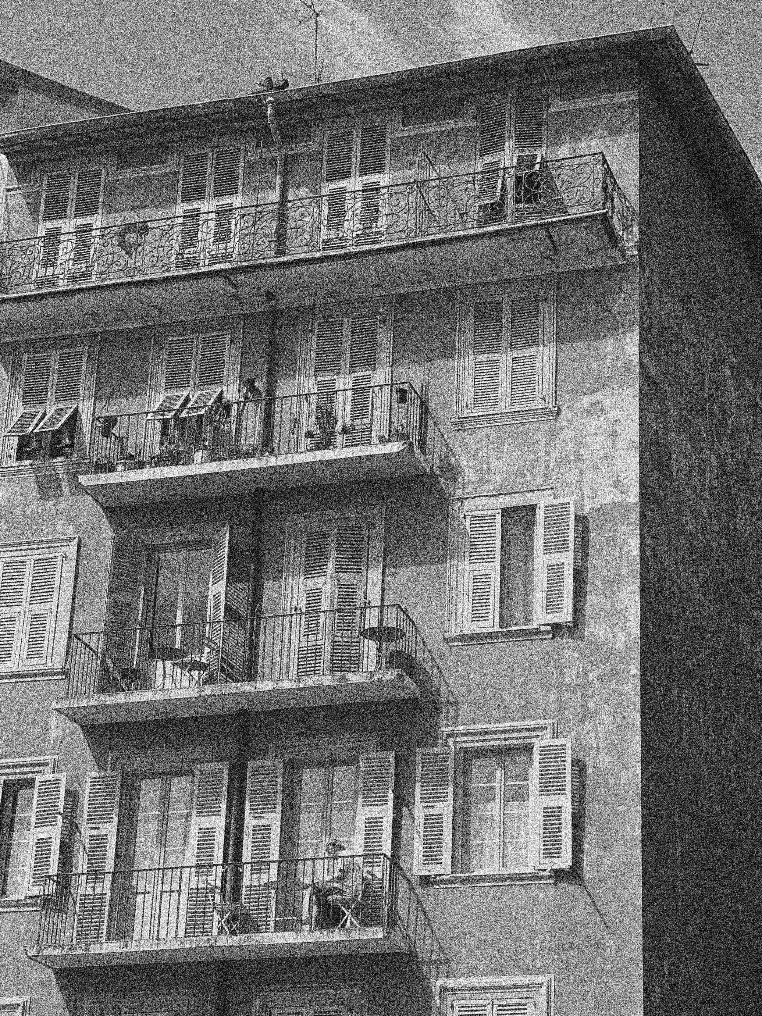 A LADY ON HER BALCONY IN NICE, FRANCE