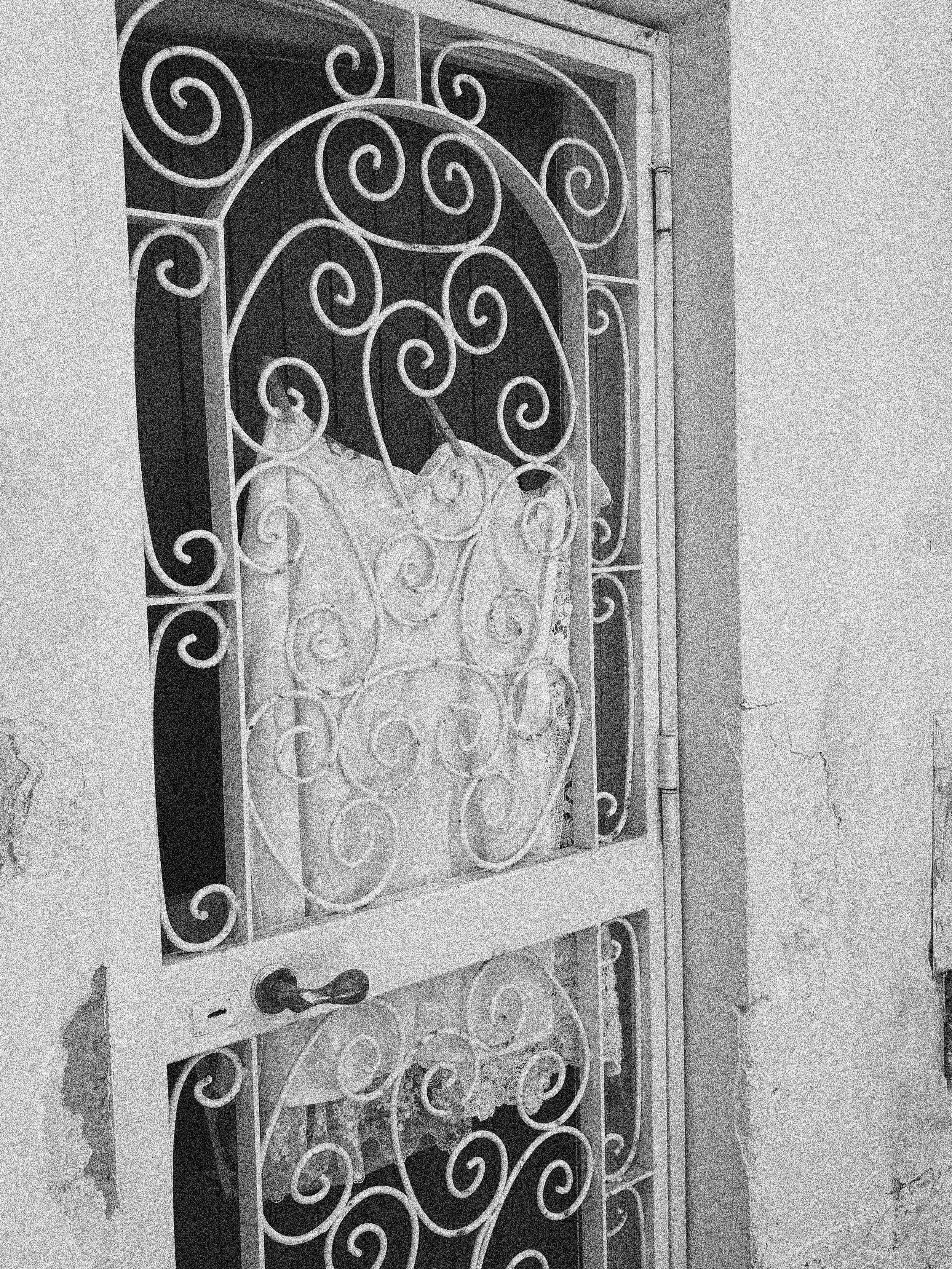 FRESHLY LAUNDERED LINENS IN A DOOR FRAME IN VICO EQUENSE , ITALY