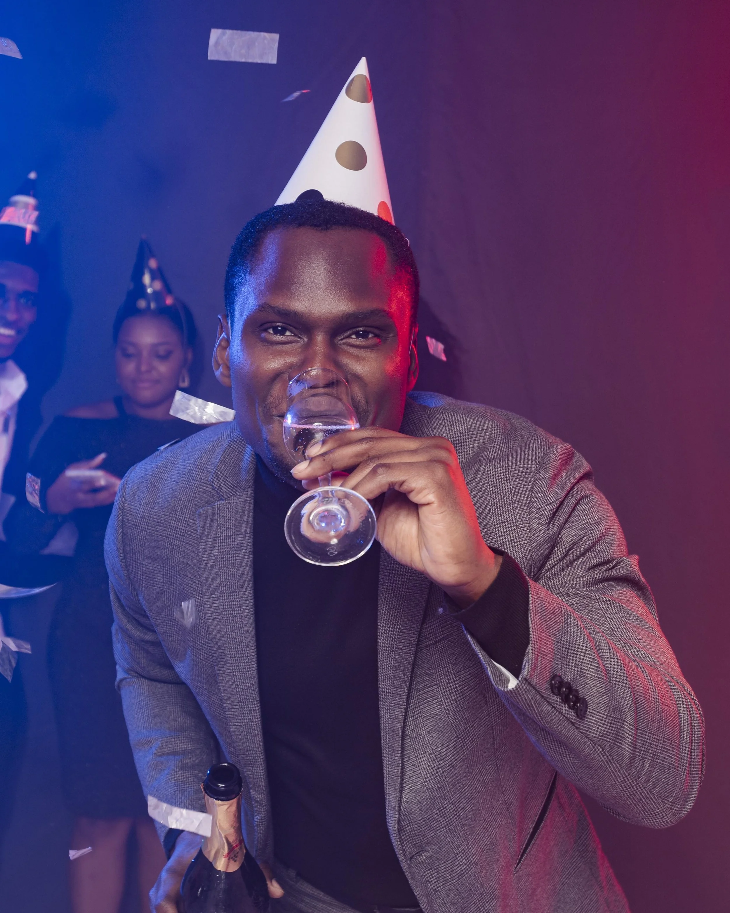 man-wearing-party-hat-drinking-champagne.jpg