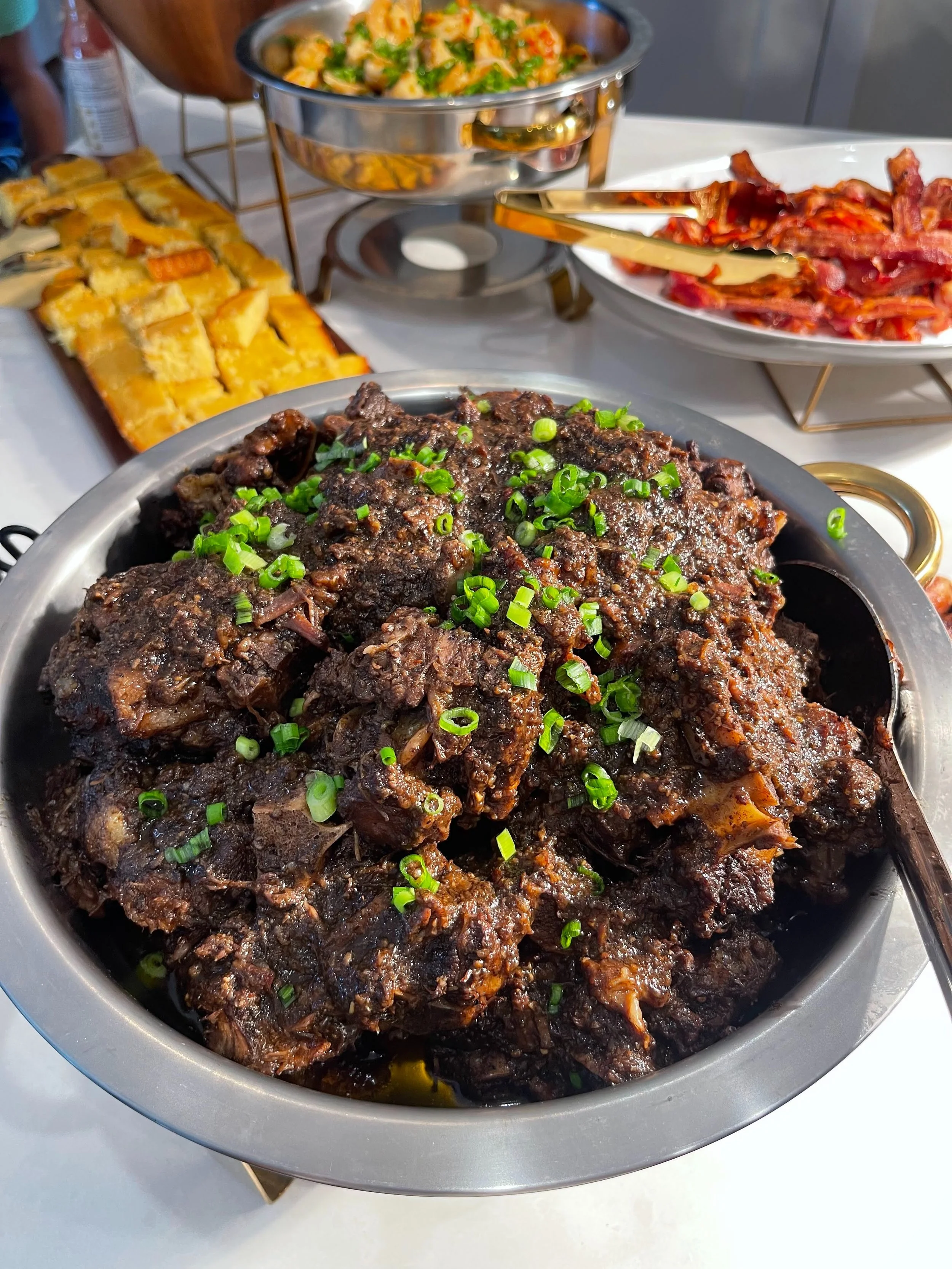 Dish of braised oxtails topped with chopped green onions