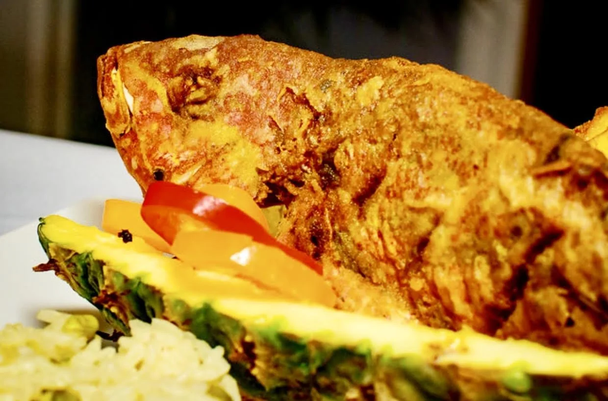 Snapper and peppers in pineapple