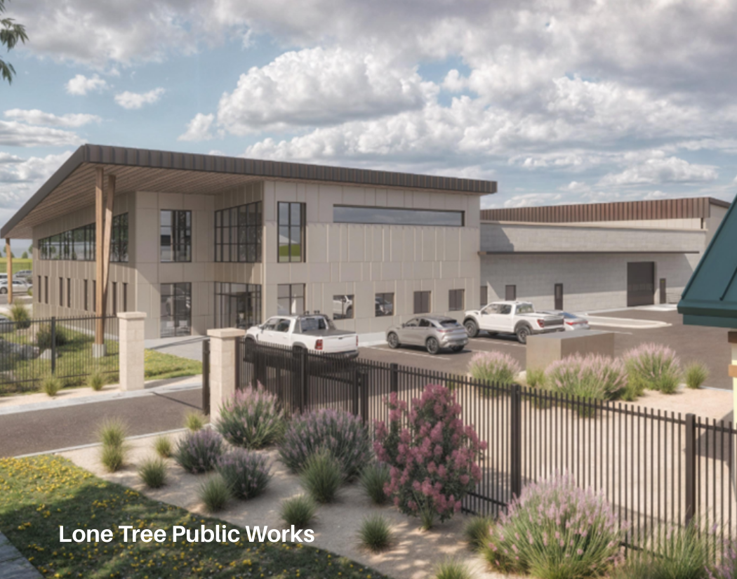 Rendering of a modern commercial building with a parking lot, surrounded by landscaped bushes and trees, under a partly cloudy sky.