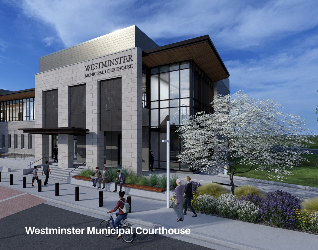 A modern Westminster Municipal Courthouse building with glass and stone exterior, people walking and sitting outside, a flowering tree, and landscaping with grass and flowers.