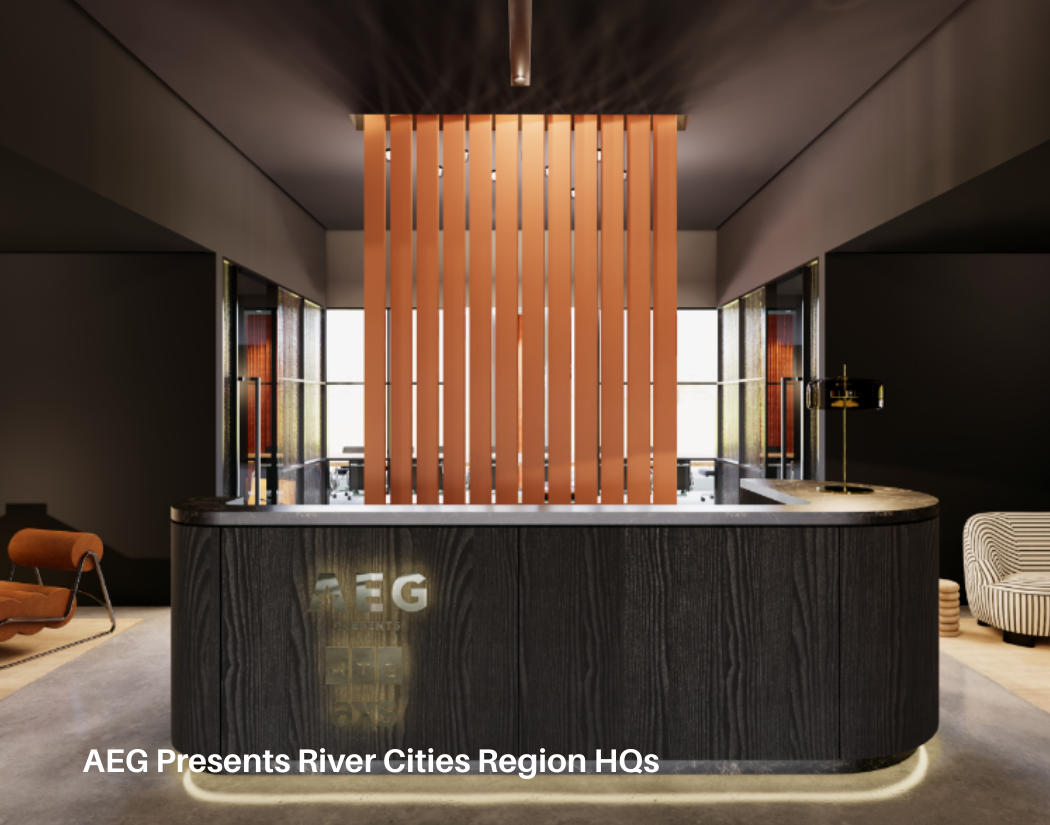 Modern reception area with a dark wood curved counter and a vertical wooden slat divider. The background features large windows, and there are chairs on either side of the reception.