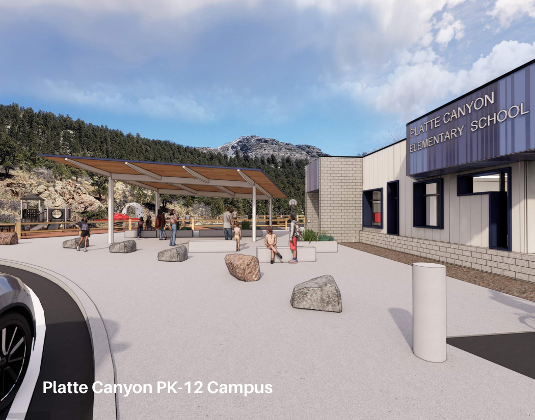Rendering of Platte Canyon Elementary School outdoor area at Platte Canyon PK-12 Campus, featuring a shelter with benches, students waiting, and the school building in the background, set against a mountainous landscape with partly cloudy sky.
