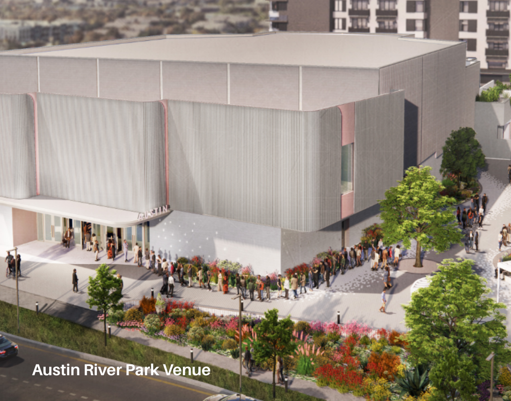 A large modern building labeled 'Austin River Park Venue' with people lining up outside on a paved walkway, surrounded by trees and landscaped flower beds.