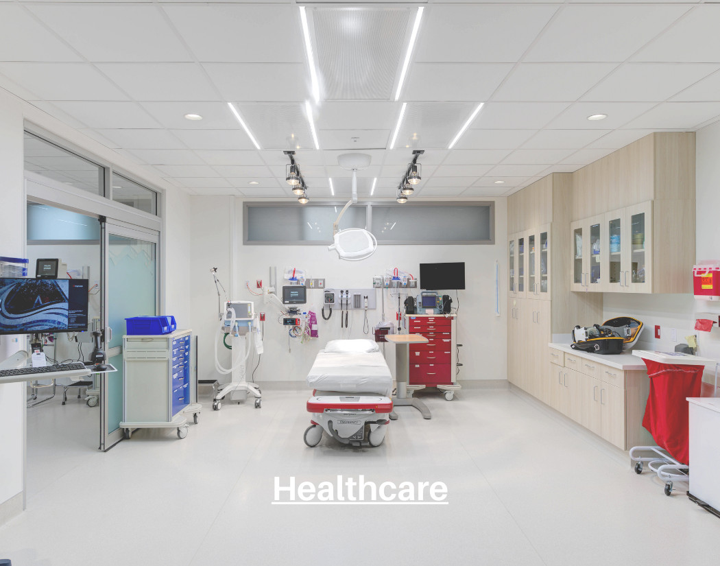 Empty hospital operating room with medical equipment, a patient bed, and overhead lighting.
