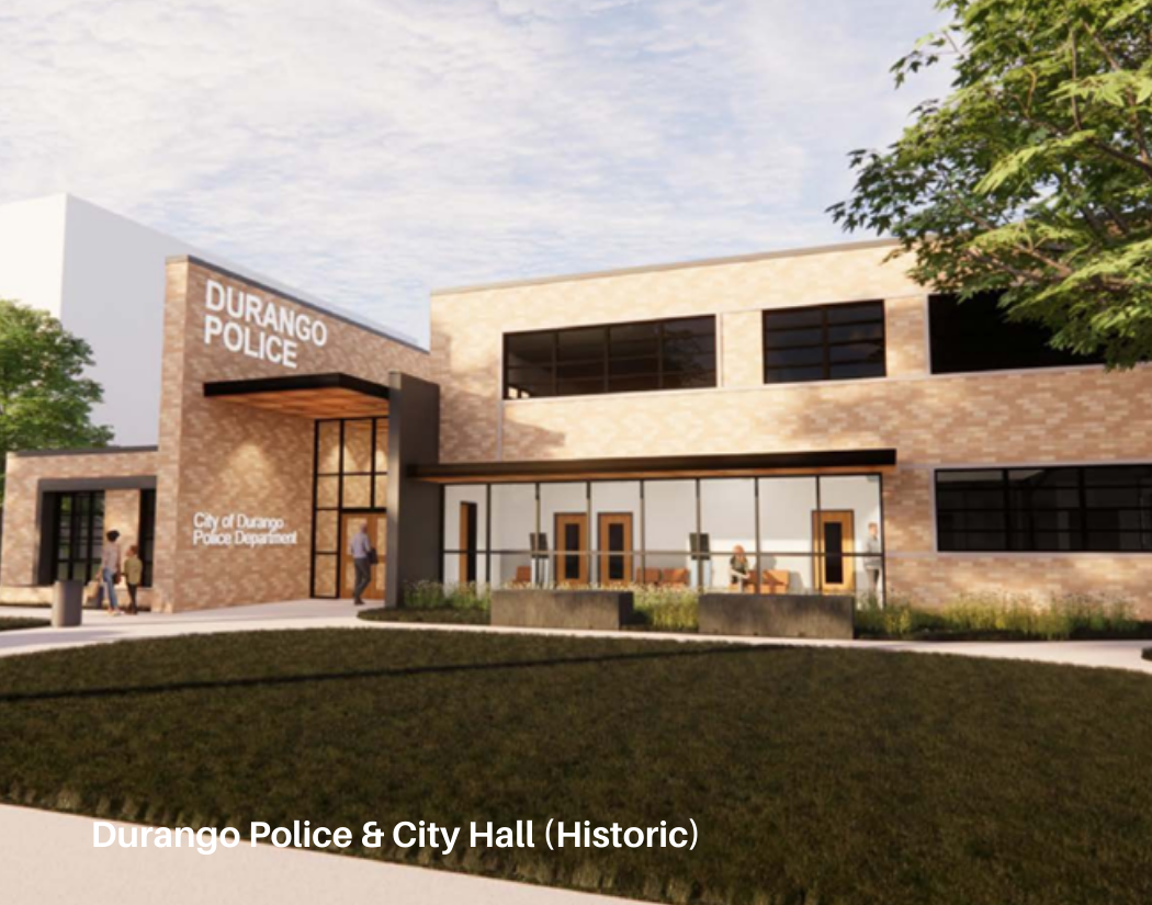 A modern two-story brick building labeled 'Durango Police' and 'City of Durango Police Department' with large windows and a glass entrance. People are walking nearby, and there is a tree on the right side.