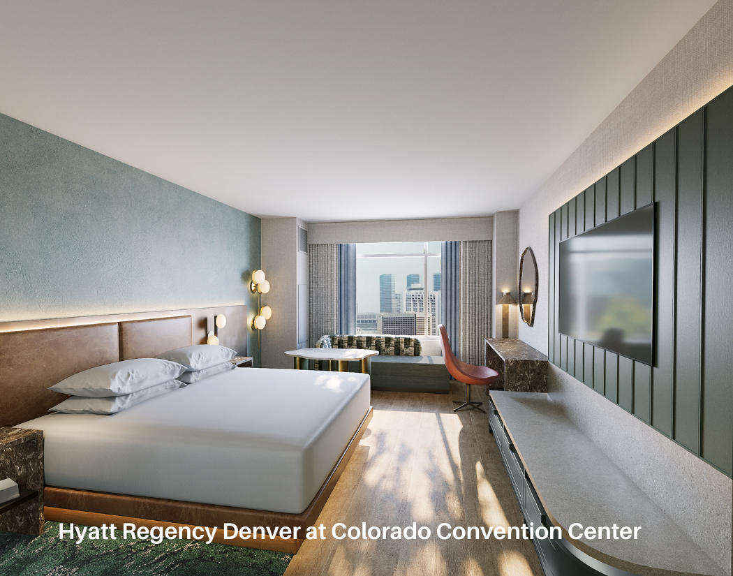 Hotel room with a large bed, window seat with city view, wall-mounted TV, and modern decor at Hyatt Regency Denver.