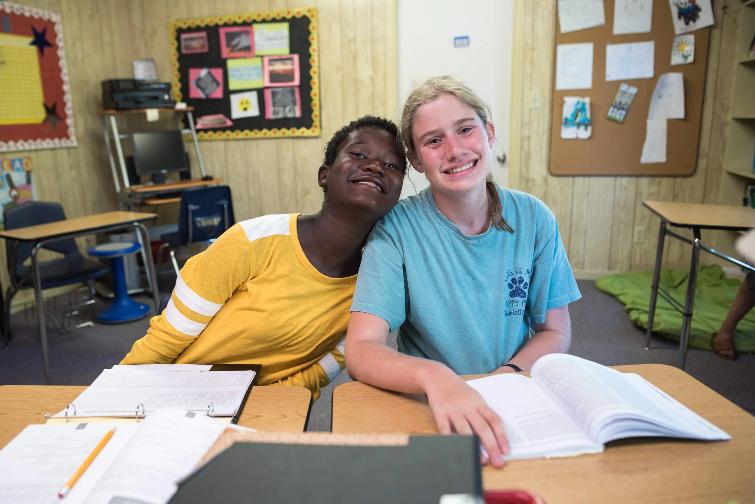 Oakland School students smiling while they study
