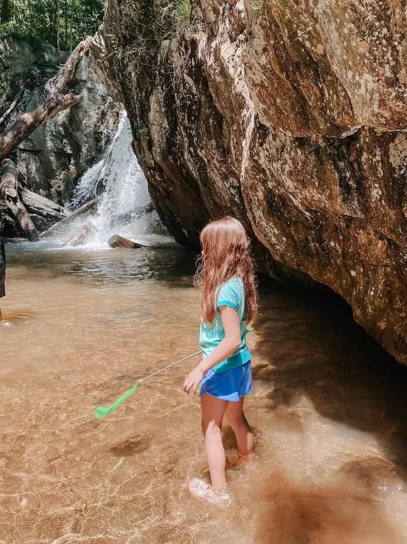 girl standing in water next to the kilgore falls in harford county