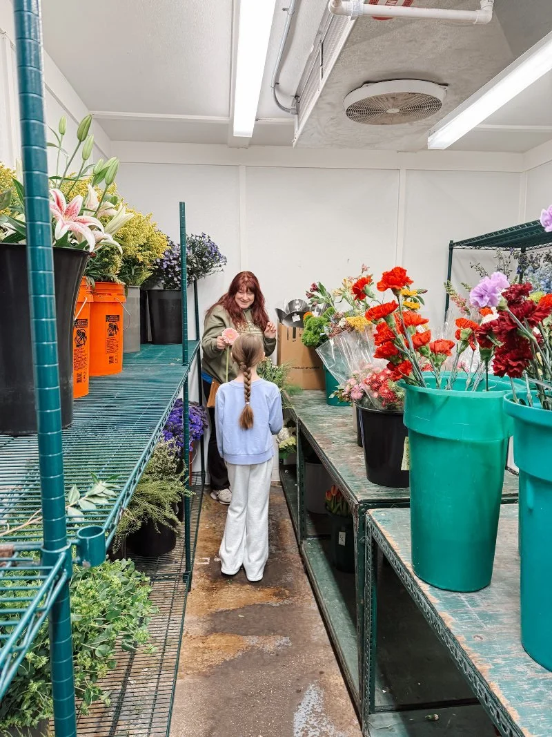 florist handing a flower to a customer at richardson's flowers and gifts in bel air maryland