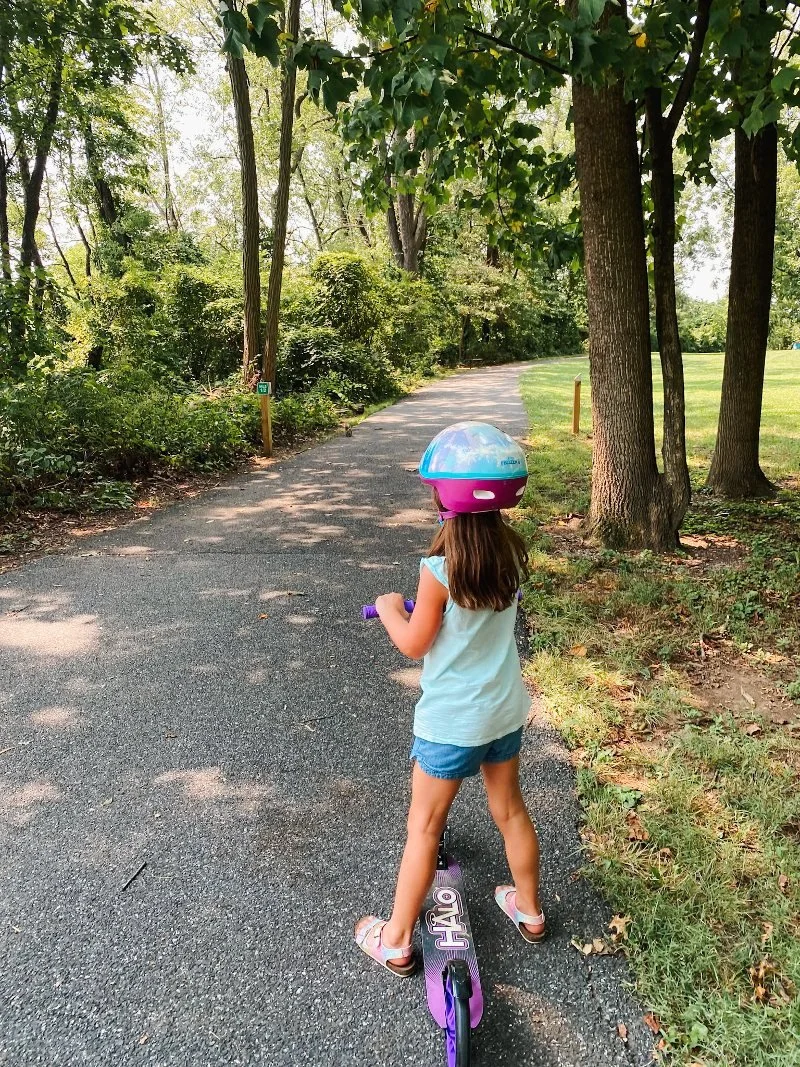 girl riding a scooter at mariner point park in joppatowne, md