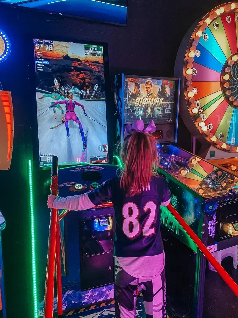 girl playing arcade game at jurassic golf in bel air, maryland