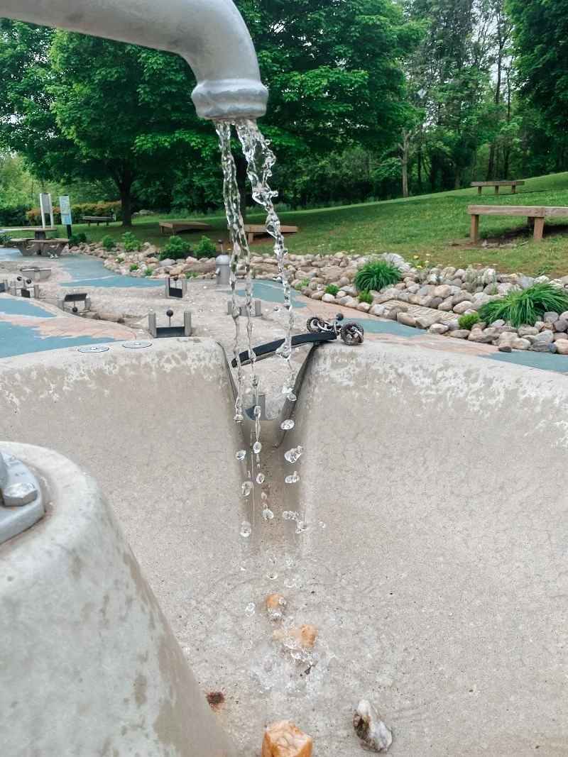 water running through an interactive element at the Chesapeake Sensory Plaza located within Rockfield Park in Bel Air MD