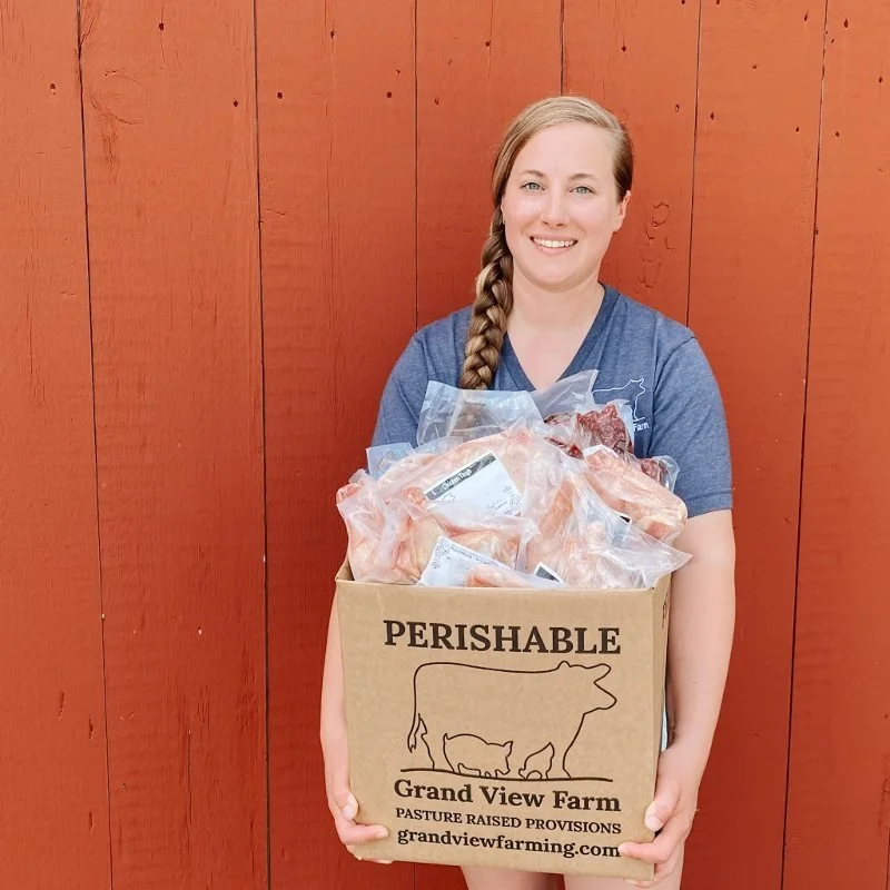 farmer holding a box of pasture raised meats from grand view farm in harford county maryland