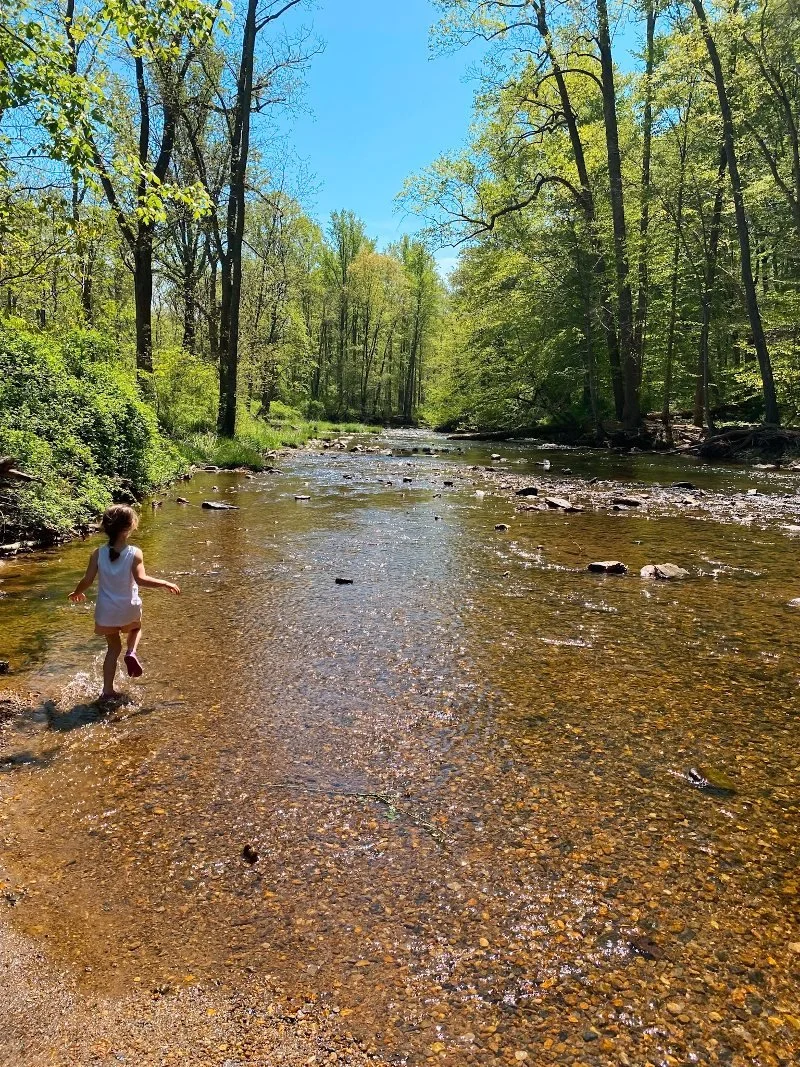 girl running through the gunpowder river at jerusalem mill in kingsville, maryland