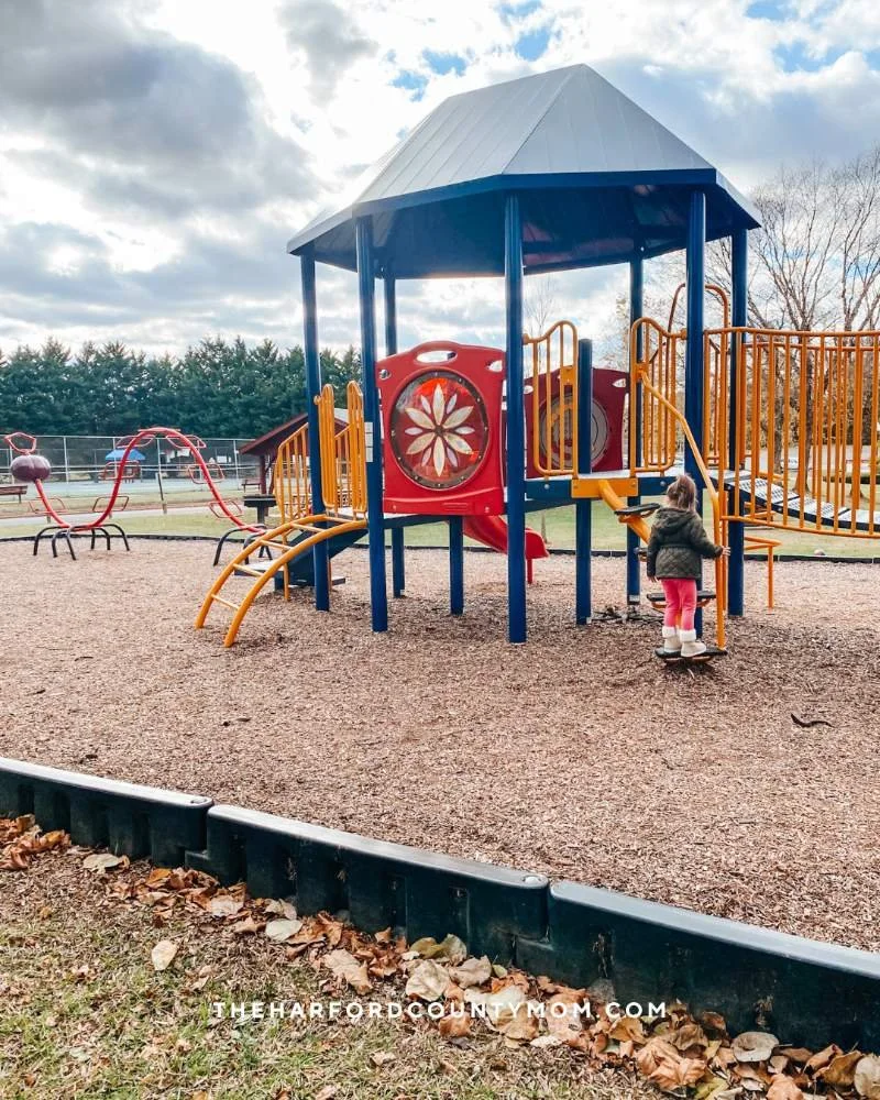 Red, yellow, and blue play structure with bridge and climbing elements at Churchville Recreation Center in Churchville, MD is perfect for all ages