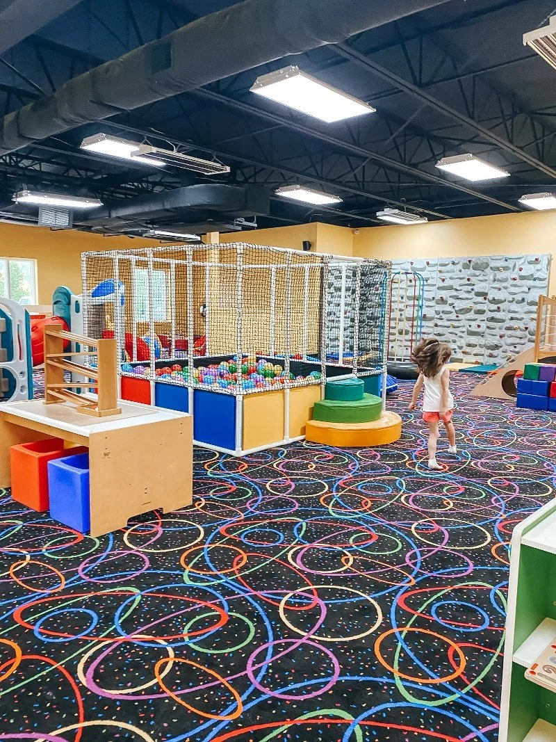 girl running through the playroom in forest hill excited to explore and play