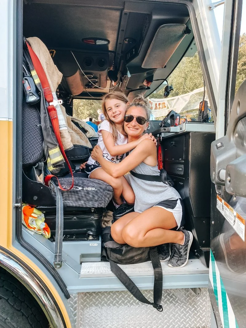 girl hugging mom on a fire truck in bel air maryland