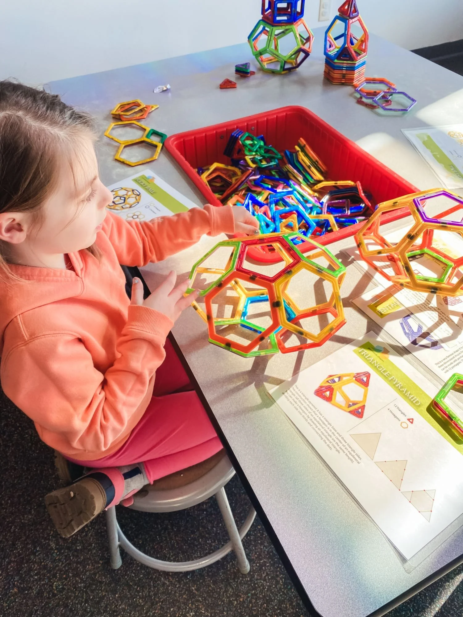 Girl plays with colorful connecting hexagons at Lancaster Science factory in Lancaster, PA