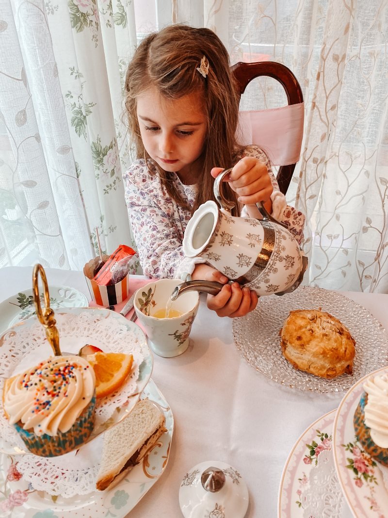 girl pouring tea at bella's tea room in havre de grace maryland