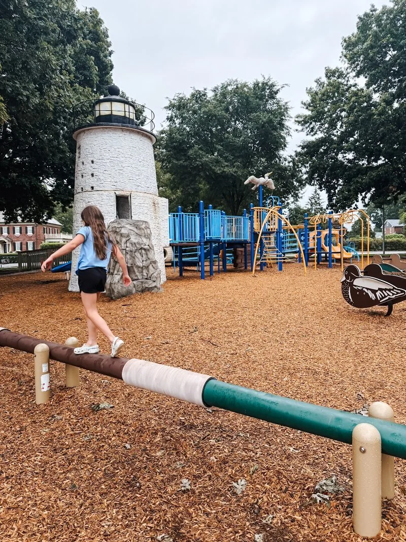 girl walking along a balance beam at the millard tydings park playground