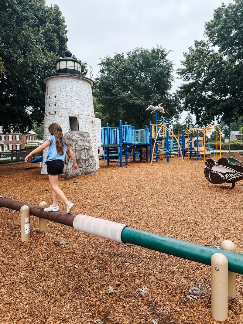 girl walking a balance beam at millard Tydings park in havre de grace maryland