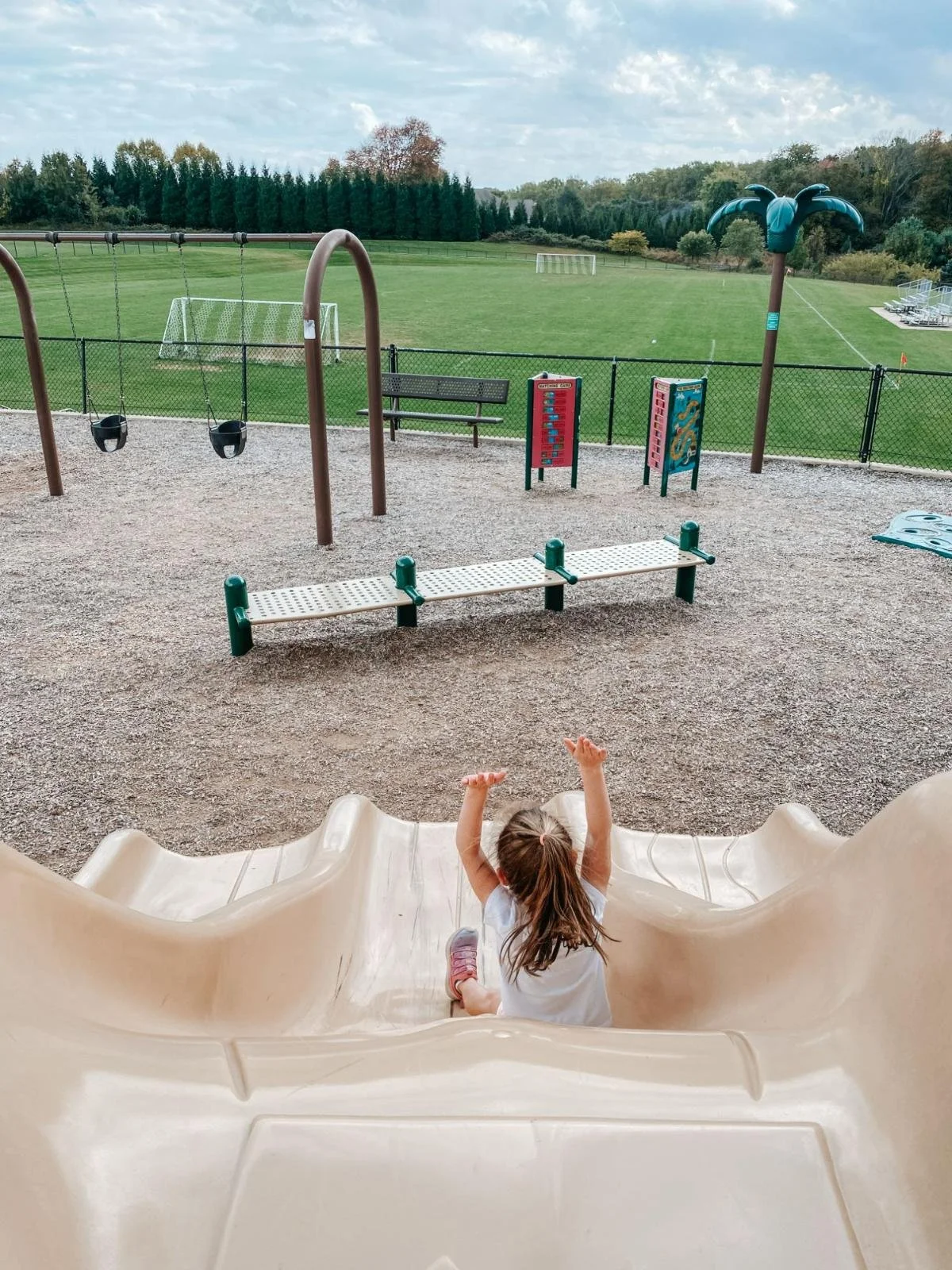 Girl goes down slide at local playground representing how The Harford County Mom got started with a conversation with another mom at a park