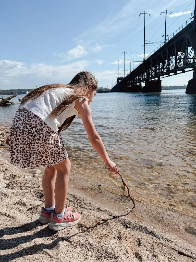 girl playing in the sand at david craig park in havre de grace md