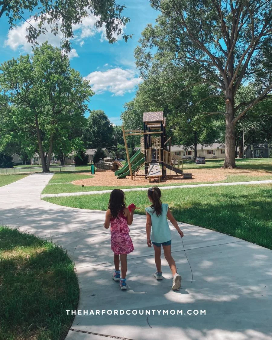 Two young girls walk along paved trail to playground at Mildred Kelly Park, which may be formerly known as Nuttal Avenue Park, in Edgewood, Maryland