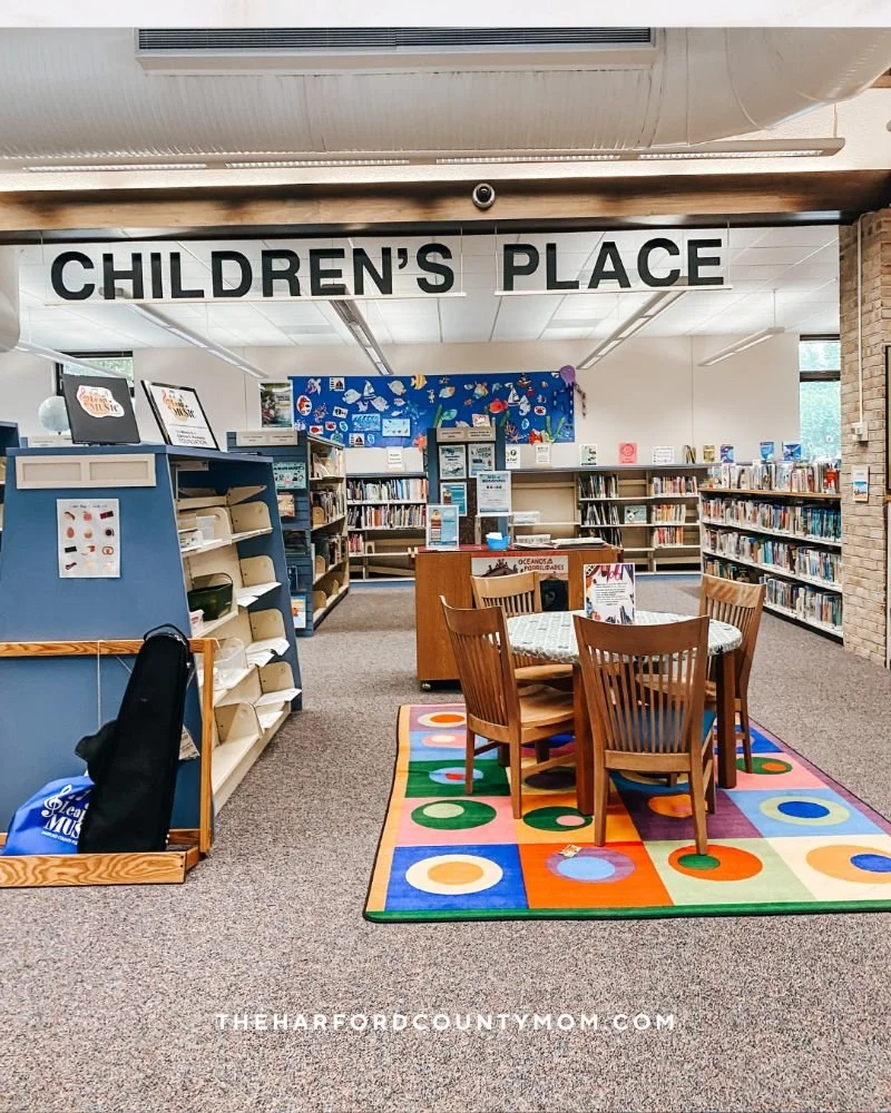 Joppa Library's "Children's Place" section of library with colorful rugs and shelves is a unique location with an option to rent fishing equipment