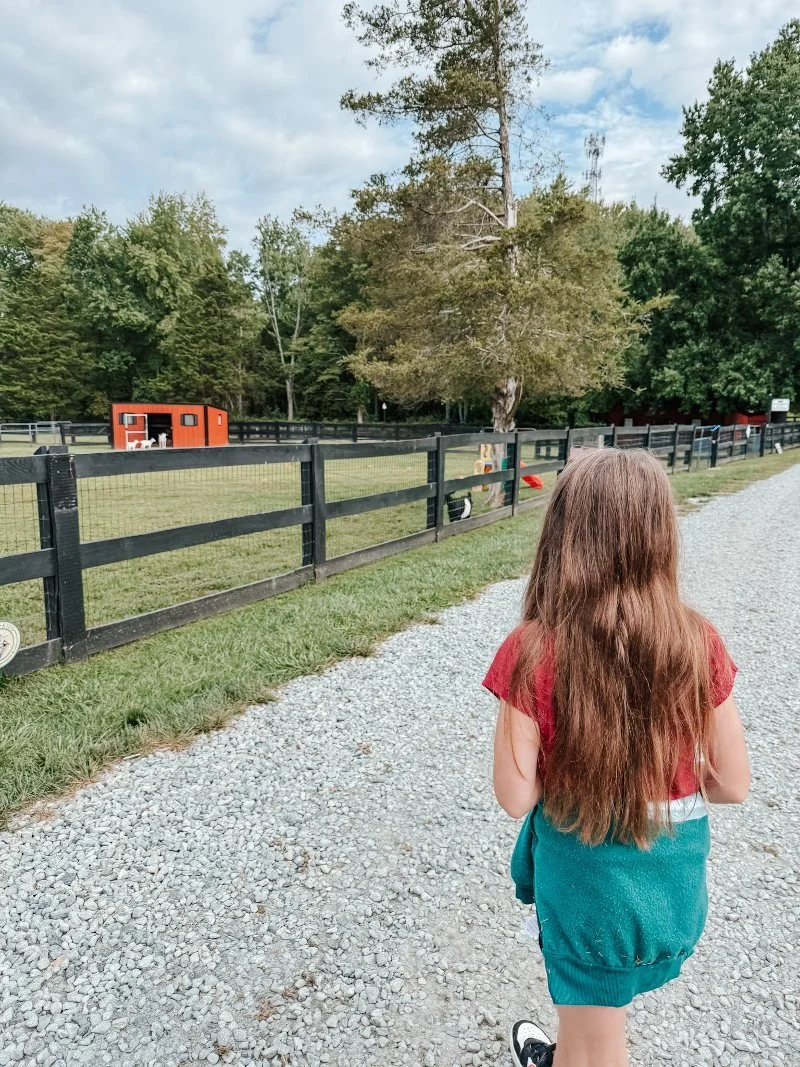 girl walking on a farm tour in bel air maryland at sunny dreams farm