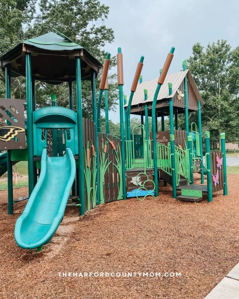 Green nature-themed play structure at William Longley Park in Abingdon, Maryland
