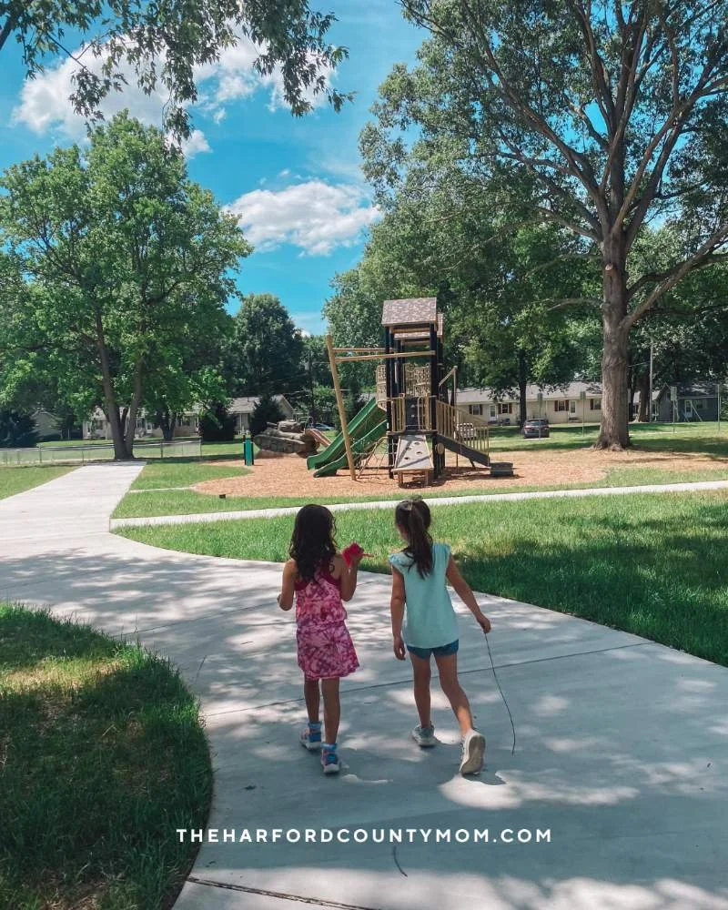 Two young girls walk along paved trail to playground at Mildred Kelly Park, which may be formerly known as Nuttal Avenue Park, in Edgewood, Maryland