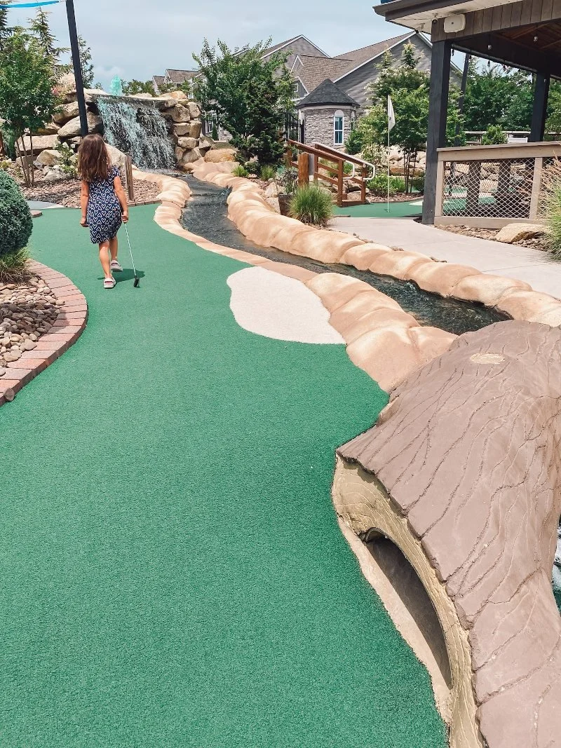 girl walking along the mini golf course at mountain run mini golf in fallston, maryland